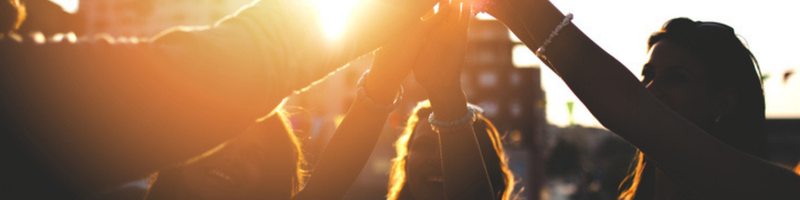 800 X200px Happy friends at the rooftop doing high five stock photo